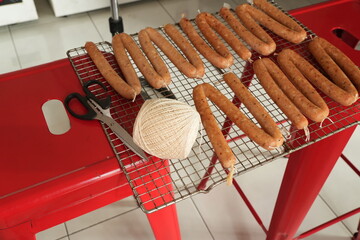 The process of making sausage using string and collagen casing