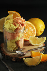 Lemon and orange ice cream scoops in glass jar	