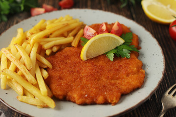 A Viennese schnizel with french fries	