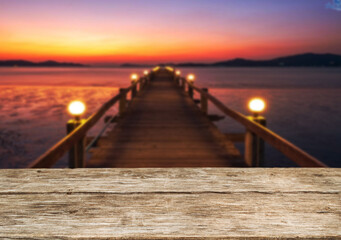 Wooden table top on blur light forest or gardent.Before sunset concept.For montage product display or design key visual layout.View of copy space.
