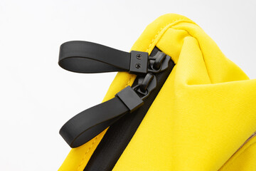 details of seam joints, fasteners and fasteners, yellow backpack made of thick fabric, insulated