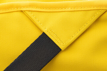 details of seam joints, fasteners and fasteners, yellow backpack made of thick fabric, insulated