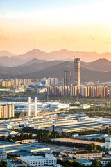 Obraz premium Aerial View of Huzhou China Cityscape at Sunset with Mountains and Modern Architecture
