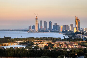 Obraz premium Aerial View of Huzhou City Skyline at Sunset, Modern Urban Landscape with Lake and Skyscrapers, Zhejiang Province China