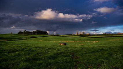 Storm Clouds Over Green New Zealand Grassland - Dramatic Weather and Lush Pastoral Landscape