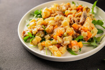 Potato salad with smoked fish tasty snack fresh delicious gourmet food background on the table rustic food top view copy space