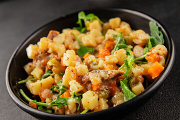 Potato salad with smoked fish tasty snack fresh delicious gourmet food background on the table rustic food top view copy space