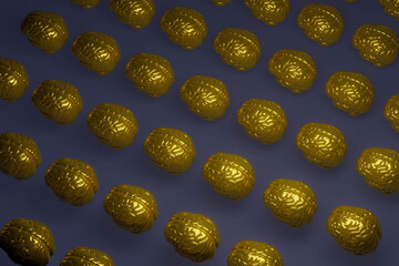 A row of gold colored heads are shown on a blue background