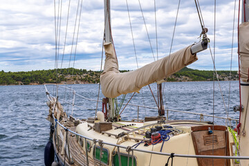 Seascape view from the bow of the boat on a cloudy day.Bow and deck of a sailboat with furled...