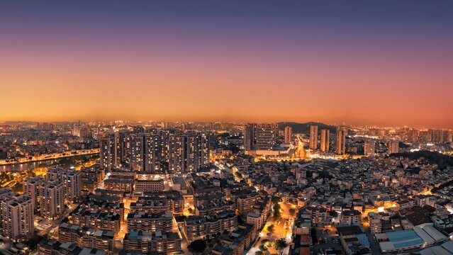 Jiangmen China City Skyline at Sunset - Vibrant Urban Nightscape with Illuminated Buildings and Streets