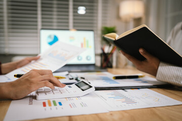 A business team engages in a meeting, discussing strategies and analyzing graphs. Colleagues review documents, reports, and data, collaborating on planning, finance, leadership, performance, and proje
