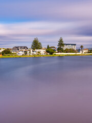 Vertical long exposure of Milnerton Lagoon and houses, Cape Town, South Africa