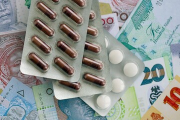Nigerian naira currency money bills and medicine pills. The concept of medicine and pharmacy