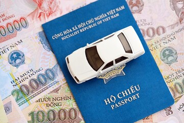 Vietnamese dong currency money bills and car with passport. The concept of car ownership