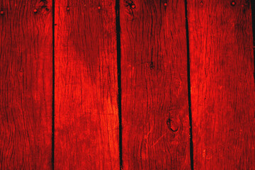 Red painted wooden plank wall with nail heads. Rustic background texture for design projects, interior decor, or construction materials concepts.
