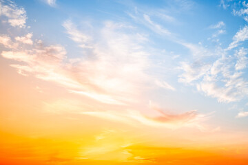 Obraz premium Beautiful , luxury soft gradient orange gold clouds and sunlight on the blue sky perfect for the background, take in evening,Twilight, Large size, high definition landscape photo