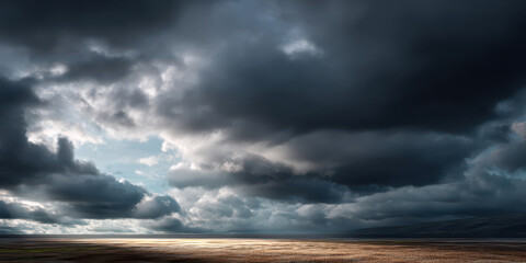 Obraz premium Dark clouds gather over vast open field with sunlight breaking through, creating dramatic and moody landscape scene