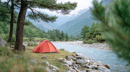 A traveler prepares a bright tent along a tranquil riverbank, embraced by lush greenery and majestic mountains under natural light in daylight conditions