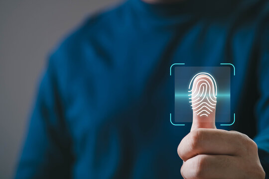 A person uses a thumbprint scanner, showcasing biometric technology for identification and security.