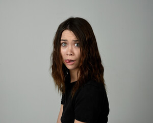Obraz premium Brunette Girl Model Head and Shoulders Studio Portrait Fresh Faced and Pretty Showing expression emotional upset Expressions