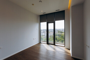 A Modern Empty Room Featuring a Panoramic View and Abundant Natural Light Inviting Comfort