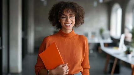 Confident young african female professional holding folder in office setting