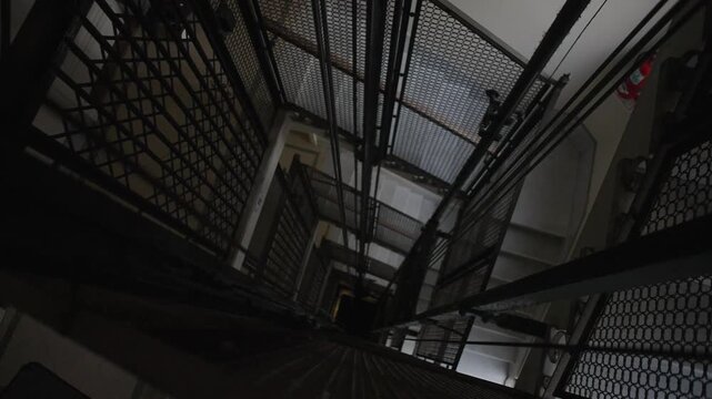 Old vintage elevator in a historic building with classic metal details and folding doors. Perfect for concepts of nostalgia, architecture and heritage.