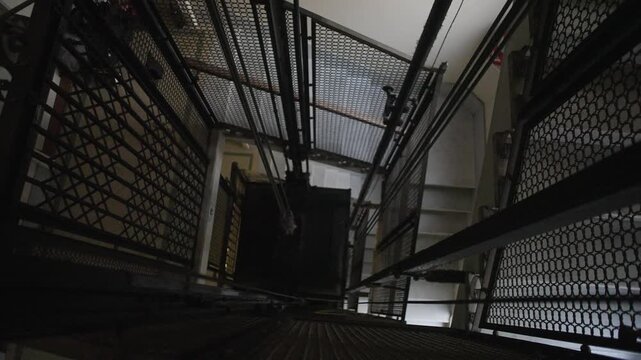 Old vintage elevator in a historic building with classic metal details and folding doors. Perfect for concepts of nostalgia, architecture and heritage.