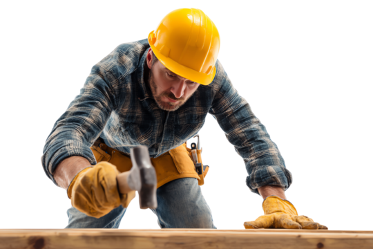 Construction worker in a yellow hard hat and gloves, hammering a wooden beam with focus and precision.