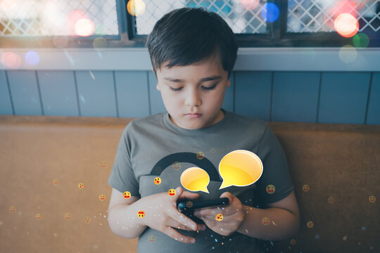 School child using smartphone with chat bubbles and emojis, highlighting digital communication, classroom peer interaction and raising awareness about cyberbullying and online behavior in education