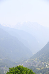 Picturesque alpine landscape with green valley and mountain forest in Switzerland