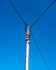 Telecommunication pole isolated against deep blue sky