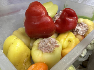 stuffed red and green peppers in the refrigerator