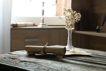 Old paper scrolls and sheets on wooden table