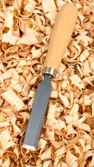 Wood chisel on wood shavings
