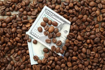 Dollar banknote and coffee beans on table, top view