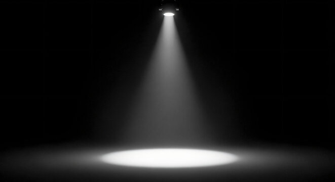 A single spotlight shines down from above, illuminating a circular area on a dark, empty stage.