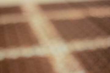A dreamy view of a brown metal grid.
