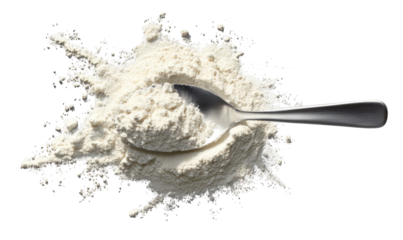 A metal spoon filled with flour, surrounded by a splatter of flour