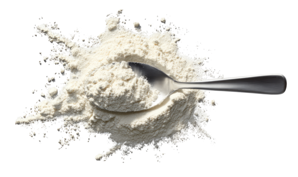 A metal spoon filled with flour, surrounded by a splatter of flour