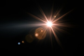 Bright starburst light effect on dark background with lens flare