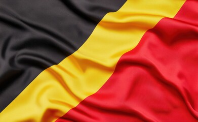 Fototapeta premium Black Red and Yellow Flag Textile Fabric with Wave Patterns