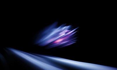 A blurry image of a purple and blue light with a black background