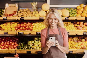 Blonde saleswoman engages with customers in a vibrant organic grocery store