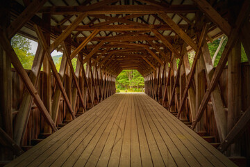 Interior beams and a wooden footpath line the Historic Bennett Bean Covered Bridge in Lincoln...