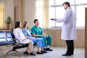 Senior doctor is discussing and brainstorming with his medical school student in the patient ward...