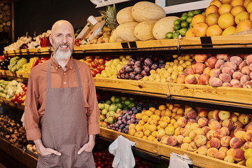 Salesman promotes fresh local produce in vibrant farmers market store