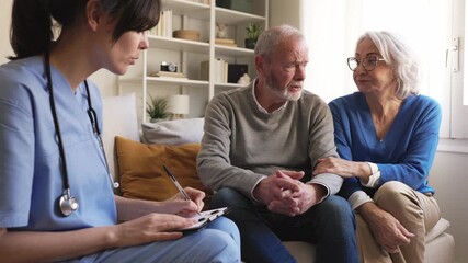 Nurse visiting elderly couple at home for healthcare consultatin - Powered by Adobe