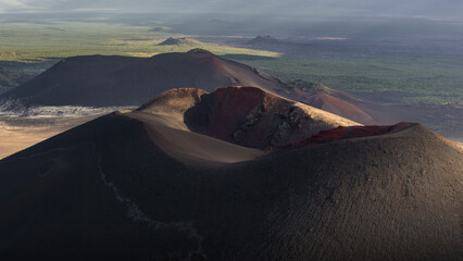 Majestic volcanic landscape showcasing rugged mountain peaks, vibrant green vegetation, and...