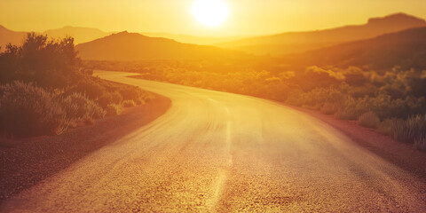 A winding desert road through sunbaked red canyons
